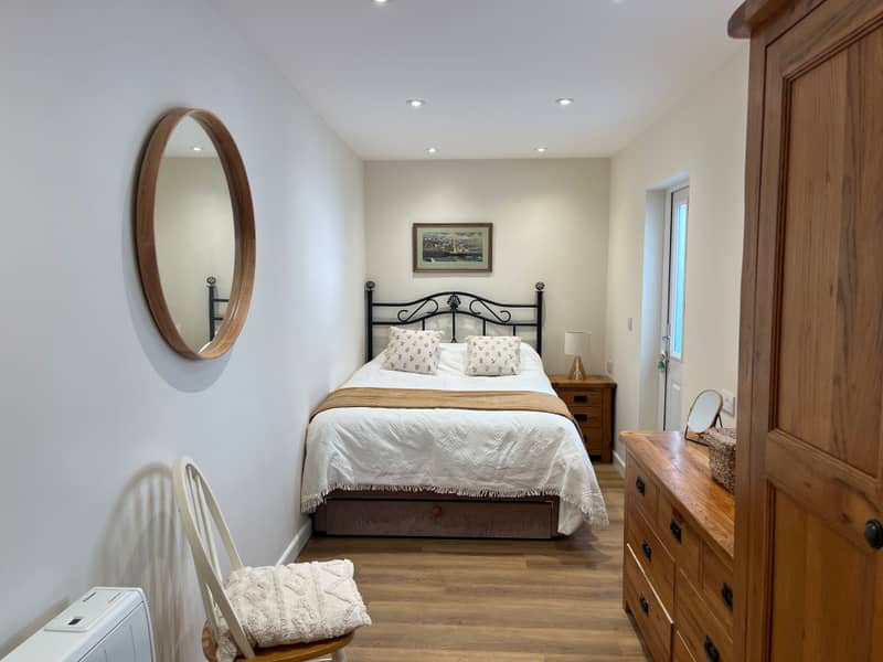 Second bedroom with iron-framed bed