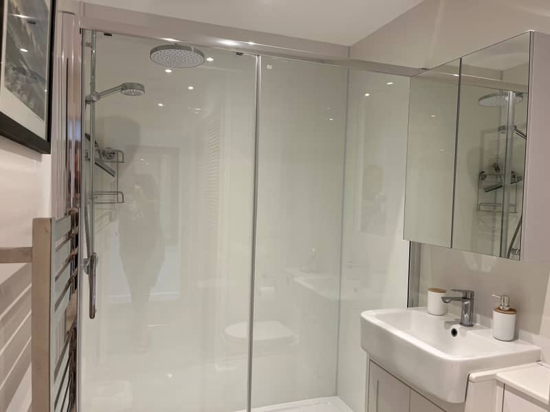 Bathroom with rainfall shower, basin and mirror cabinet