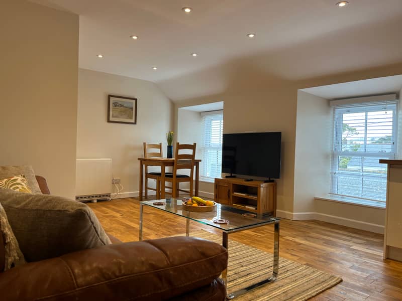 Open-plan living space of The Loft with views over St Just rooftops